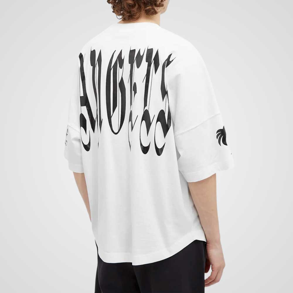Person wearing Palm Angels oversized graphic T-shirt in a streetwear outfit, relaxed fit, urban style
