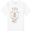 Explore the Casablanca Casa Way T-Shirt, a sporty tee made from organic cotton. This white T-shirt features a lively design depicting a building, flowers, oranges, and tennis rackets. The words "Casa Way" and "Equipment Sportif" beautifully frame the vibrant illustration.