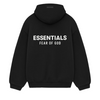 The Fear of God ESSENTIALS HOLIDAY24 Hoodie in black is a luxury streetwear item featuring "ESSENTIALS" in bold white letters and "FEAR OF GOD" on the back. It includes a drawstring hood and long sleeves for a sleek appearance.