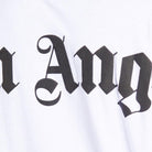 Close-up of the Palm Angels Oversize Neck Logo T-Shirt in white fabric, featuring bold, black gothic-style text that partially spells out a word, suggesting an edgy logo print by Palm Angels.