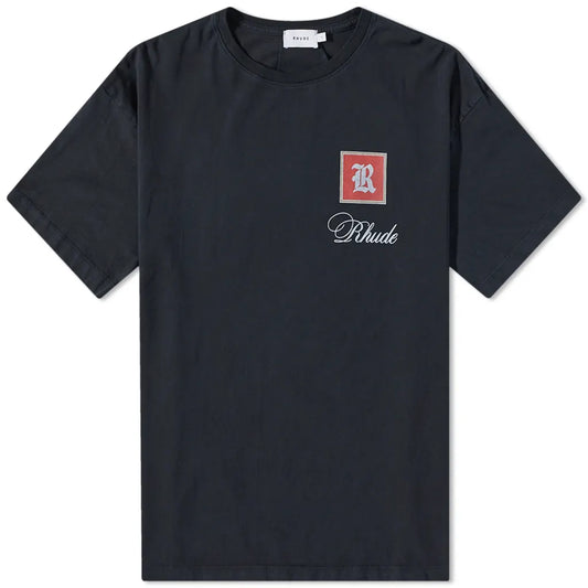 The Rhude Monaco T-Shirt from the brand Rhude is a sleek black streetwear t-shirt with a distinctive red square logo on the left chest, prominently featuring an "R" with "Rhude" stylishly scripted beneath it. It's perfect for those who love a touch of racing-inspired fashion.