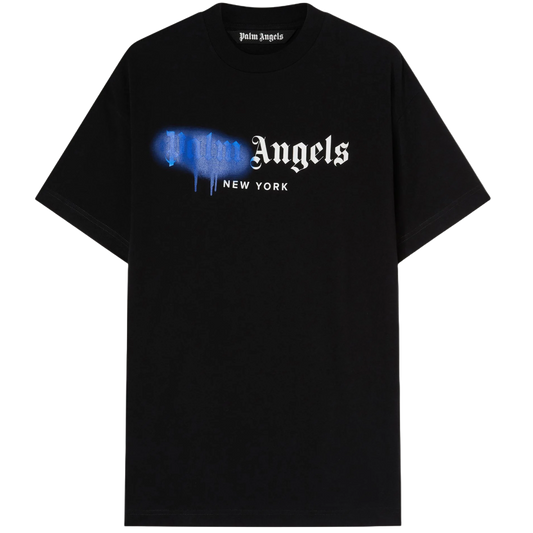 This "Palm Angels New York Sprayed Logo T-Shirt," by the brand Palm Angels, is a black tee displaying "Palm Angels NEW YORK" in white across the front, with "Palm" artistically styled in blue spray paint, capturing a simple yet modern streetwear appeal.