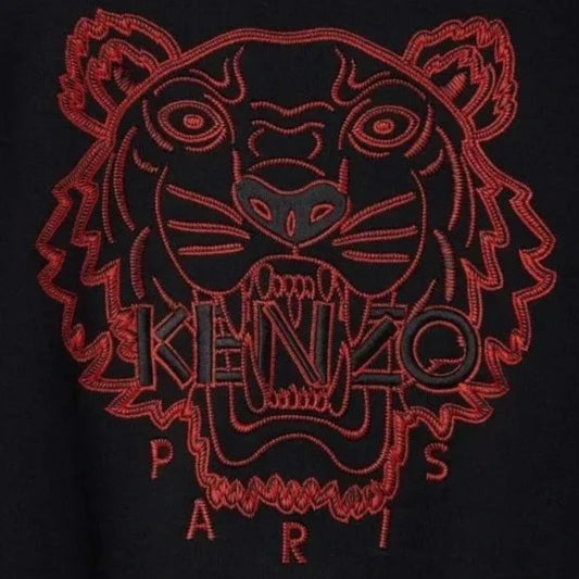 Part of Kenzo's Chinese New Year collection, the Kenzo CNY Tiger Embroidered Sweatshirt showcases a bold red tiger face embroidery with "KENZO" prominently displayed on a sleek black background, accompanied by an elegant red "PARIS" stitched below.