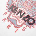 This design features a stylized tiger face in red, prominently displaying "KENZO" across it in black lettering, with "PARIS" elegantly inscribed below it in red. Reminiscent of the Kenzo White Silicone Scuba Tiger T-Shirt style, the white background enhances the intricate line details.